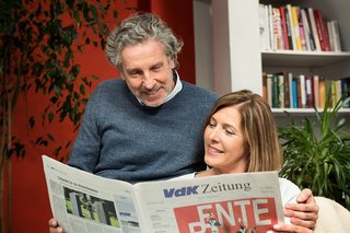 Ein Mann und eine Frau schauen gemeinsam in die VdK-Zeitung, auf der Titelseite geht es um das Thema Rente